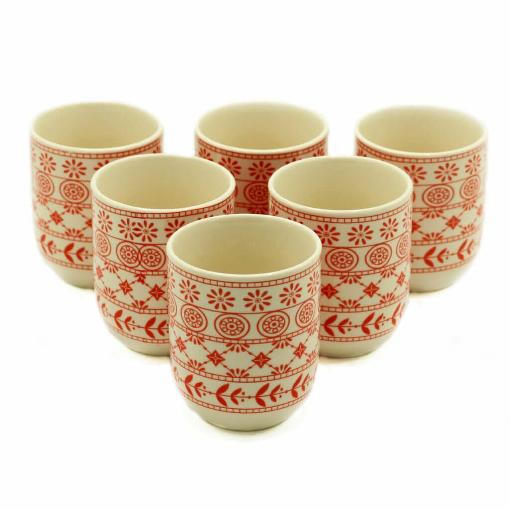 Six ceramic cups with red geometric and floral patterns arranged in two rows on a white background.